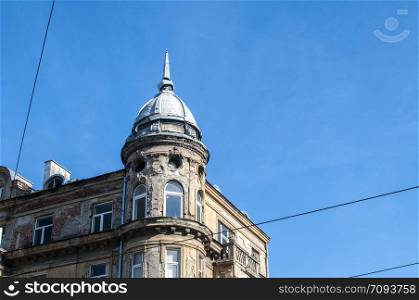 Old retro neglected beautiful city house building on clear blue sky background