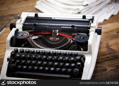 Old retro typewriter on wooden desk