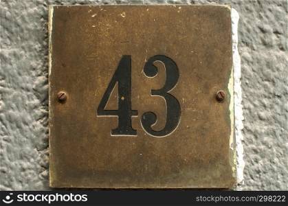 Old retro weathered cast iron plate with number 43 closeup