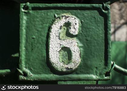 Old retro weathered painted cast iron plate with number 6