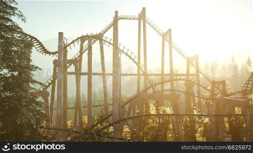 old roller coaster at sunset in forest