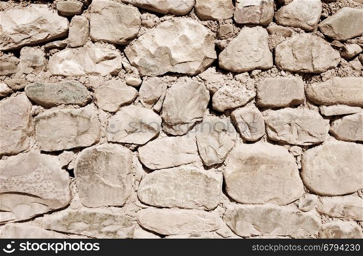 Old rough stone wall, background wallpaper
