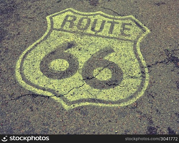 Old Route 66 sign on the asphalt.. Historic U.S. old Route 66 sign on the asphalt.