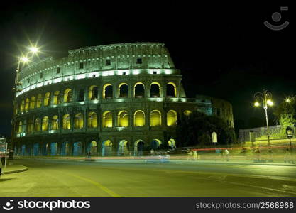 Old ruin of an amphitheater lit up at night, Coliseum, Rome, Italy