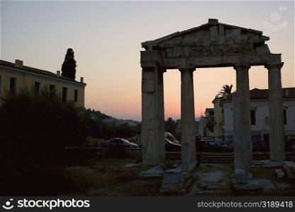Old ruins in front of buildings, Roman Agora, Athens, Greece