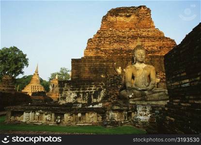Old ruins of a statue of Buddha at a temple, Si Satchanalai Historical Park, Sukhothai, Thailand