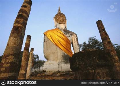 Old ruins of statue of Buddha in a temple, Wat Mahathat, Sukhothai Historical Park, Sukhothai, Thailand