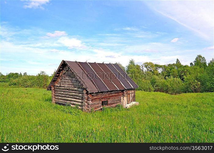 old rural house on green field