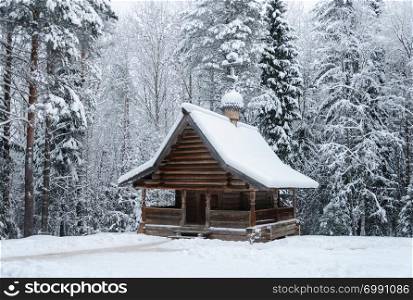 Old Russian wooden Chapel of Ilya the Prophet (18th century) in the northern open air museum Malye Korely near Arkhanglesk, Russia. Winter time.