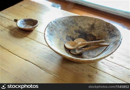 Old Russian wooden dishes on a wooden table