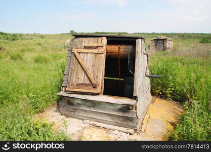 old Russian wooden draw well in the village