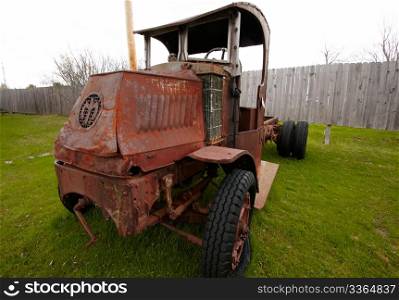 Old rusted car on the farmland.