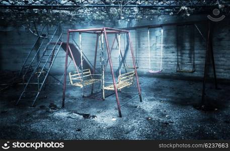 Old rusted playground, abandoned aged swings, destroyed childhood, damages in attraction park, war and poverty concept