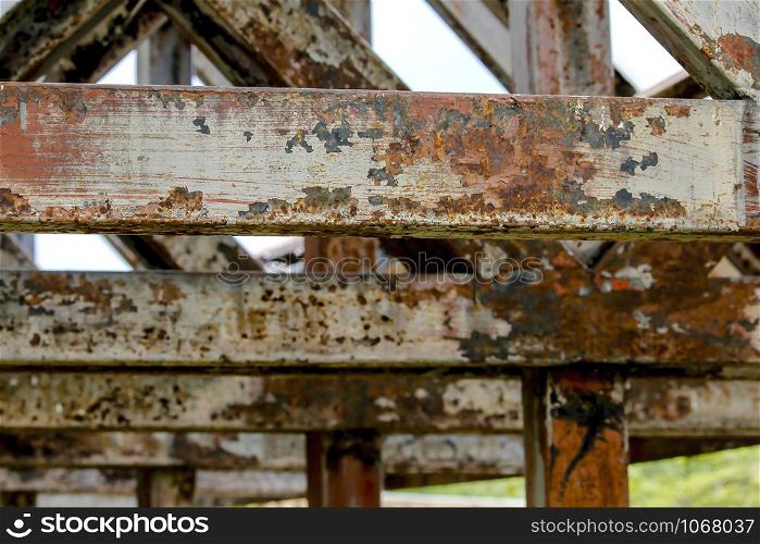 Old rusted steel roof frame and peeling off.