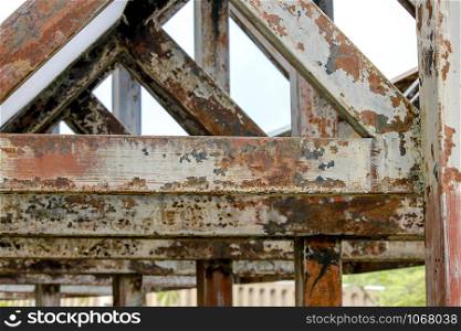 Old rusted steel roof frame and peeling off.