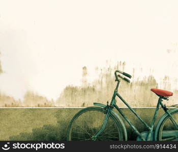 Old rustic bicycle with cement concrete wall background at the park