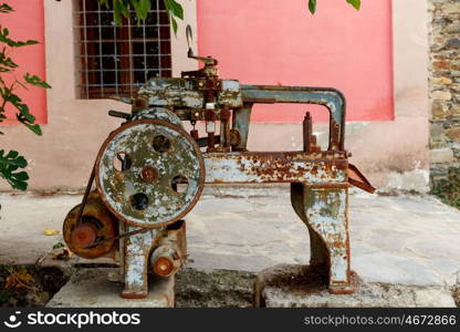 Old rusty machine located in a garden for exposition