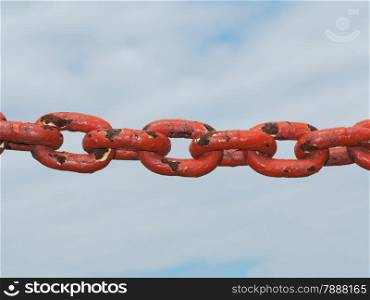 Old rusty metal steel red chain links segment. Sky cloudy background.