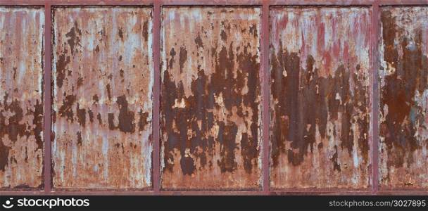 Old rusty metal wall with cracked red paint, texture background