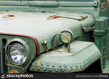 old rusty military car headlight close-up