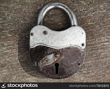 old rusty padlock on wooden background