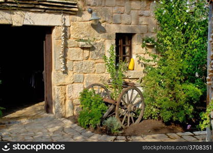 Old rusty plough in stone street of Dalmatian village