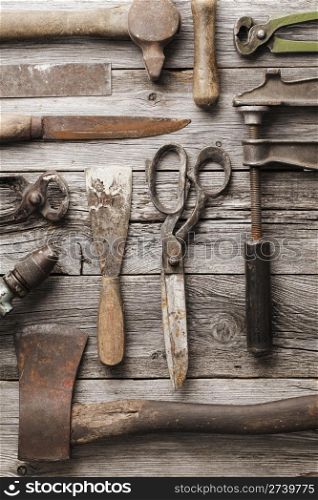 Old rusty tools on wooden background