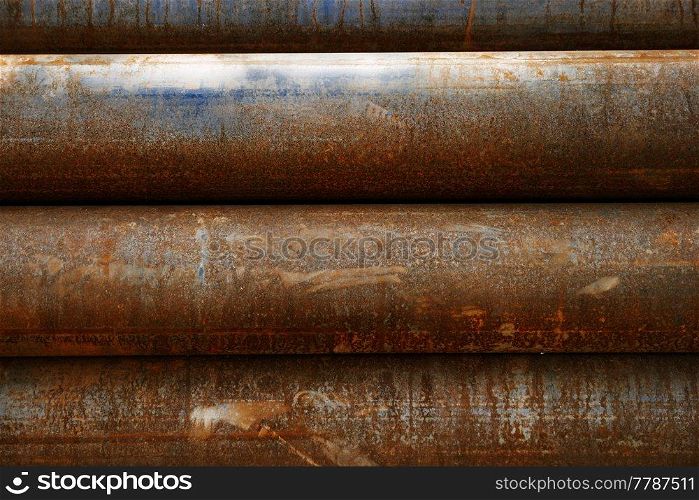 Old rusty water pipes are piled horizontally, can be used as industrial background. Old rusty water pipes are piled horizontally