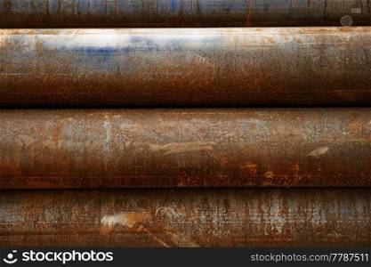 Old rusty water pipes are piled horizontally, can be used as industrial background. Old rusty water pipes are piled horizontally