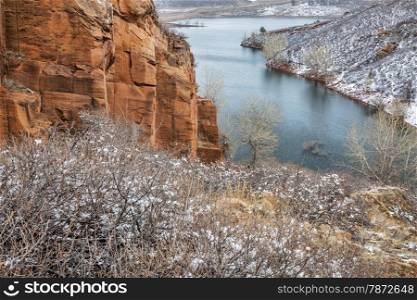 Old sandstone quarry on the shore of Horesetooth Reservoir near Fort Collins, Colorado, winter scenery with snow falling