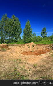 old sandy quarry in green wood