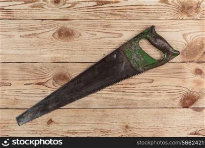 old saw on wooden background. carpentry tools on a wooden background