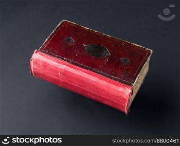old shabby book on a black background. ancient handwritten book. book on black background
