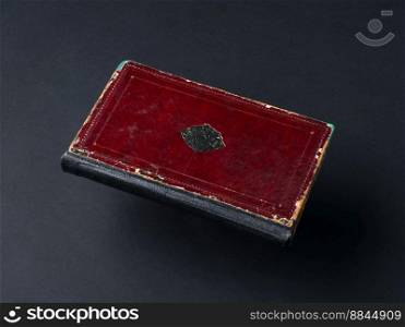 old shabby book on a black background. ancient handwritten book. book on black background
