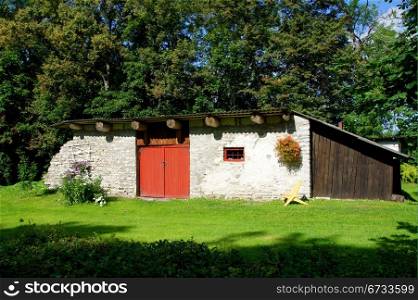 Old shed on a background of green trees