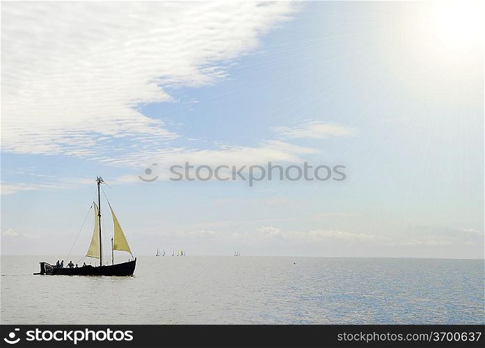 old ship sails in still sea
