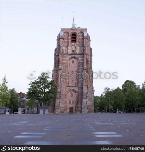 old skewed tower oldehove in capital of friesland, leeuwarden, in warm early morning light