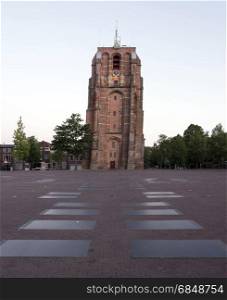 old skewed tower oldehove in capital of friesland, leeuwarden, in warm early morning light