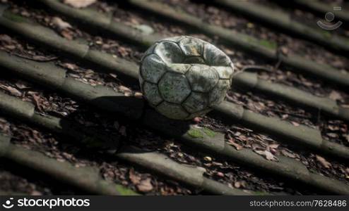 old soccer ball on the roof of a house