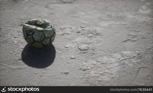 Old soccer ball the cement floor