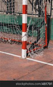 old soccer goal rope net broken in the field