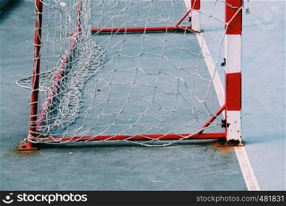 old soccer goal rope net broken in the field