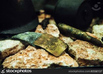 old Soviet buckle, helmet and patron of the Second World War on yellow stones