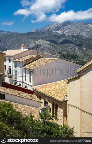 Old spanish village on mountain background. Photo.