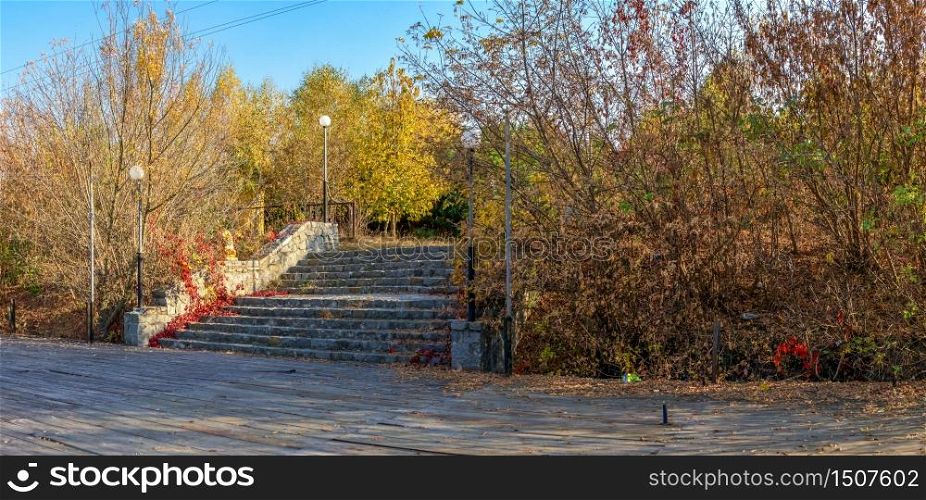 Old staircase in the park near the lake on a sunny autumn evening in the village of Ivanki, Cherkasy region, Ukraine. Old staircase in the park near the lake at fall