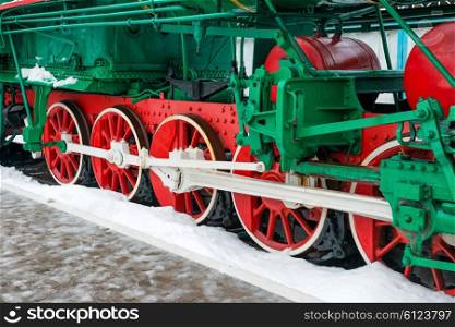 Old steam locomotive wheels on railway track closeup