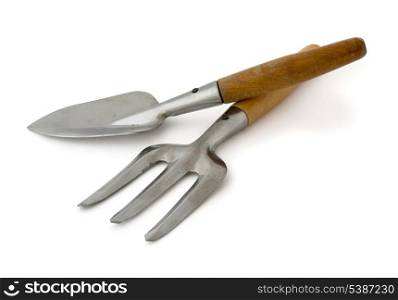 Old steel garden trowel and fork isolated on white