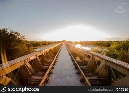 Old steel railway bridge on the river with beautiful sunset colorful. Old steel railway bridge on the river with beautiful sunset
