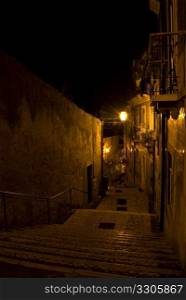 old steps leading through the old quarter Alfama in Lisbon at night
