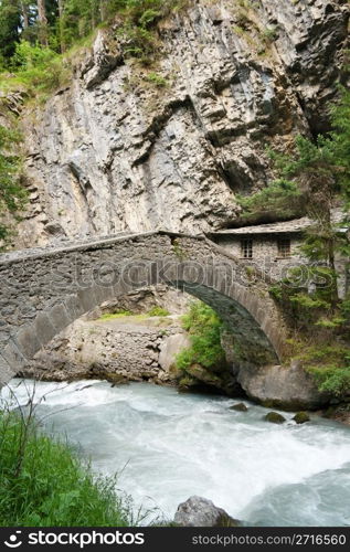 old stone bridge and home over Verney Dora in Pre Saint Didier, Aosta Valley, Italy